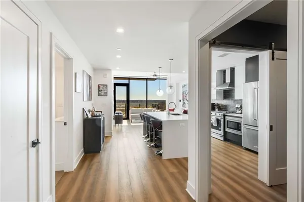 a kitchen with a refrigerator and a stove top oven