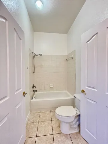 a bathroom with a tub and shower