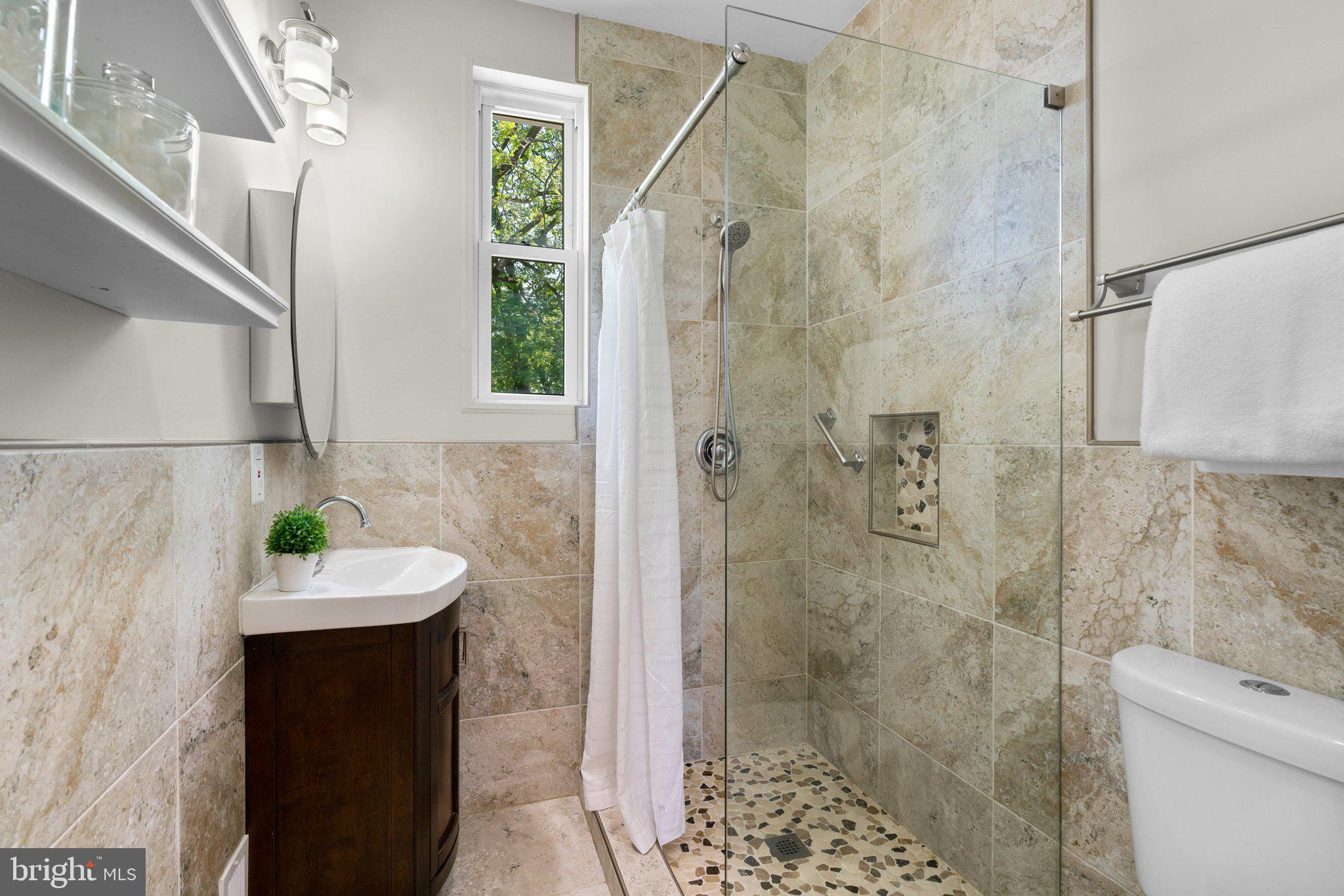 45 Edmondson Ridge Road Baltimore, MD 21228 - Photo 16 of 44 a bathroom with a sink a toilet and shower