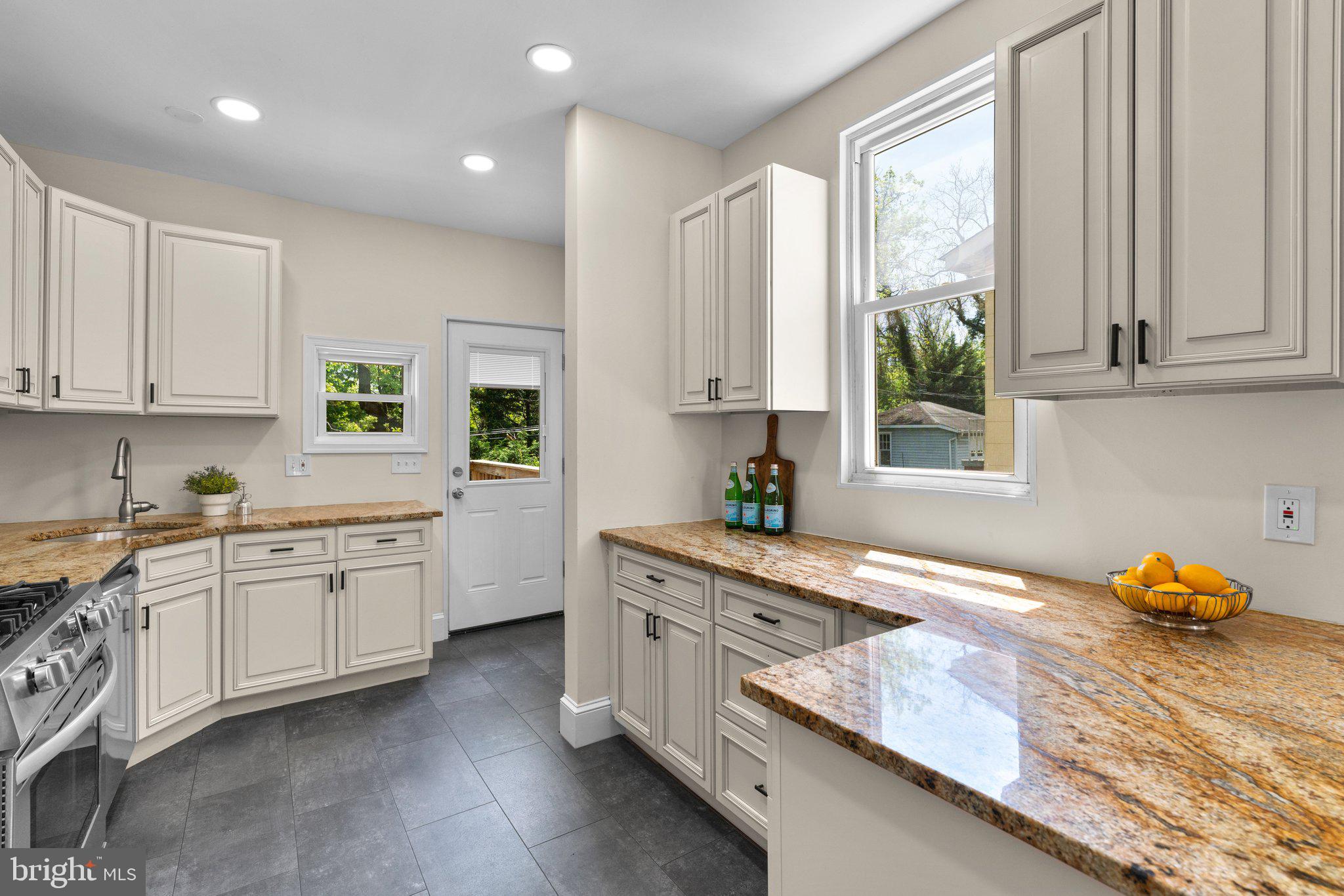 45 Edmondson Ridge Road Baltimore, MD 21228 - Photo 10 of 44 a kitchen with granite countertop white cabinets and window