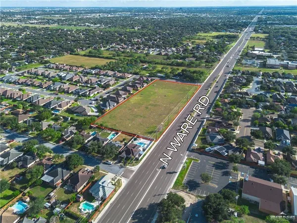 an aerial view of residential building with outdoor space and trees