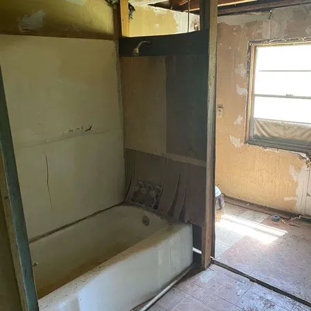 a bathroom with a bathtub and shower