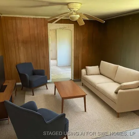 a living room with furniture and a rug