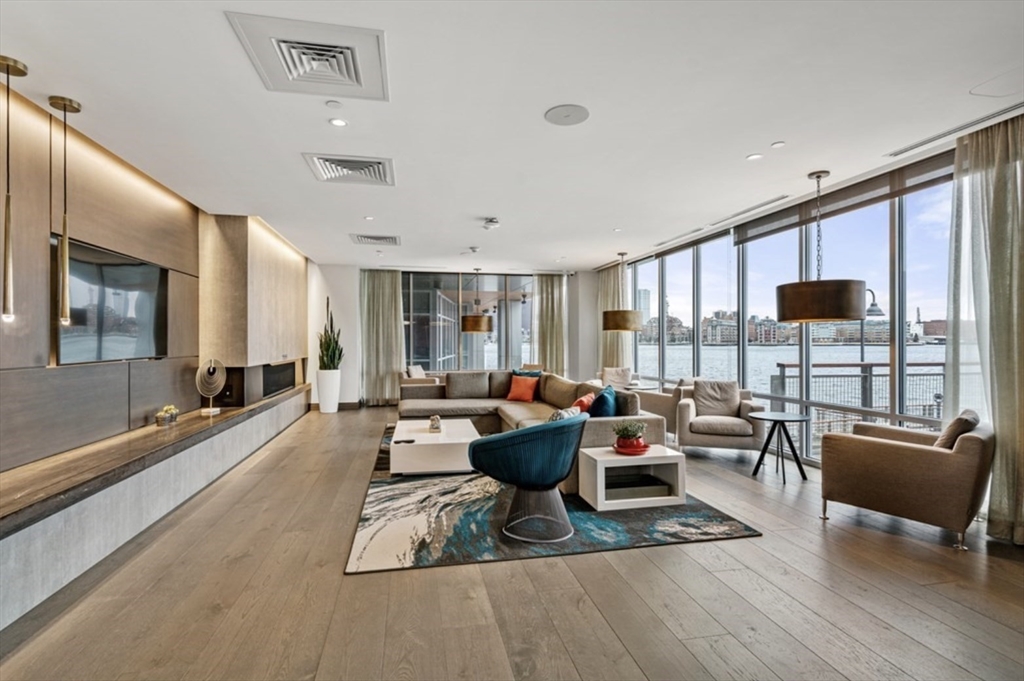 45 Lewis Street, Unit 210 Boston, MA 02128 - Photo 22 of 27 a living room with furniture and a flat screen tv