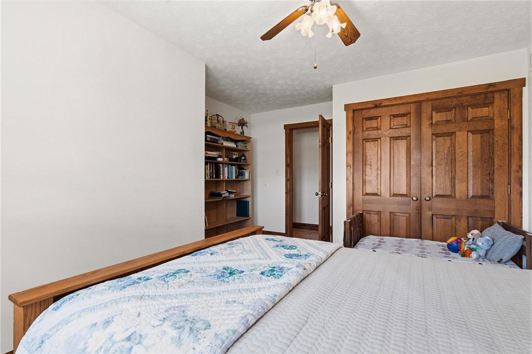 4971 Lackey Road Cedarville, OH 45314 - Photo 32 of 79 This cozy bedroom features warm wood finishes and a bright, inviting atmosphere.
