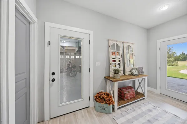 a view of a hallway with wooden floor and entryway