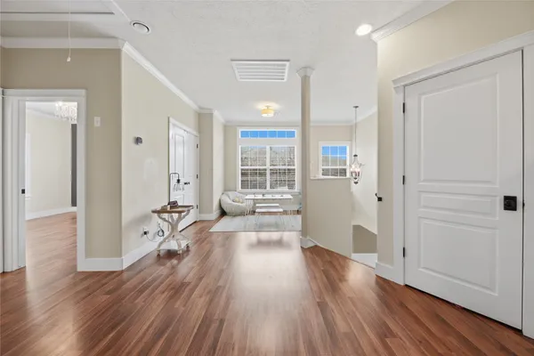 a hallway with a couch and a large window