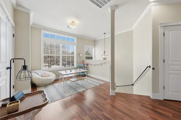 a living room with furniture and wooden floor