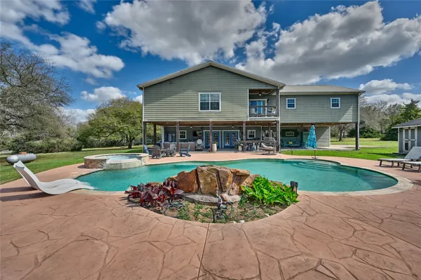 a view of a house with swimming pool and sitting area