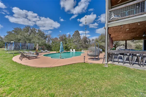 a view of a patio with dining table and chairs