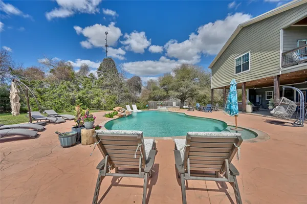 a view of a house with patio and a yard