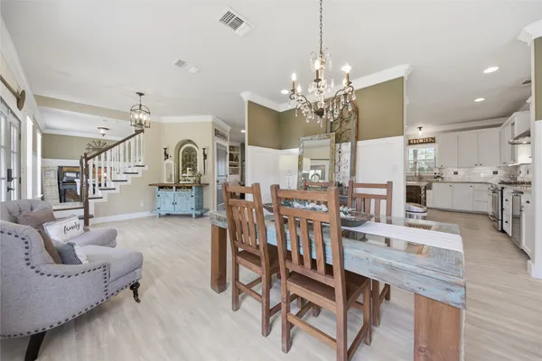 a living room with furniture a chandelier and a chandelier
