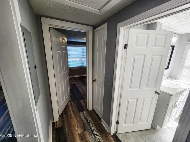 a view of a room with wooden floor and window