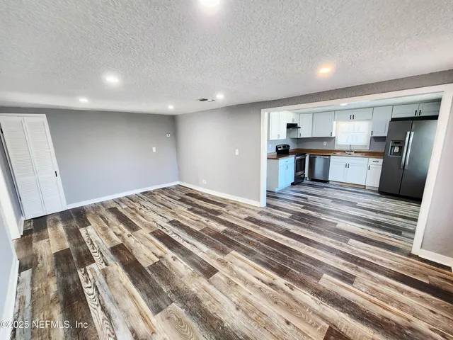 a view of kitchen and wooden floor