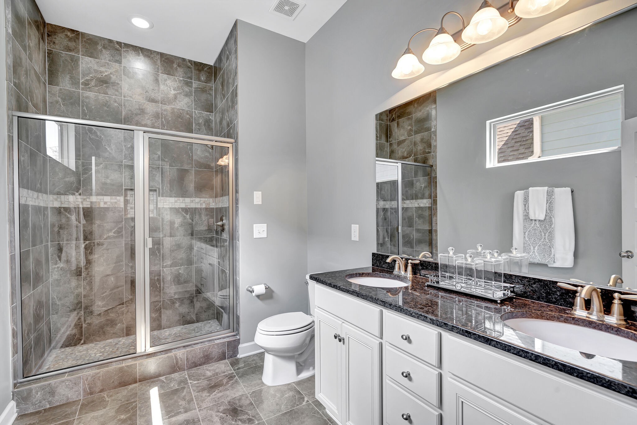 712 Bellevue Road Nashville, TN 37221 - Photo 18 of 31 a bathroom with a granite countertop sink a toilet a mirror and shower