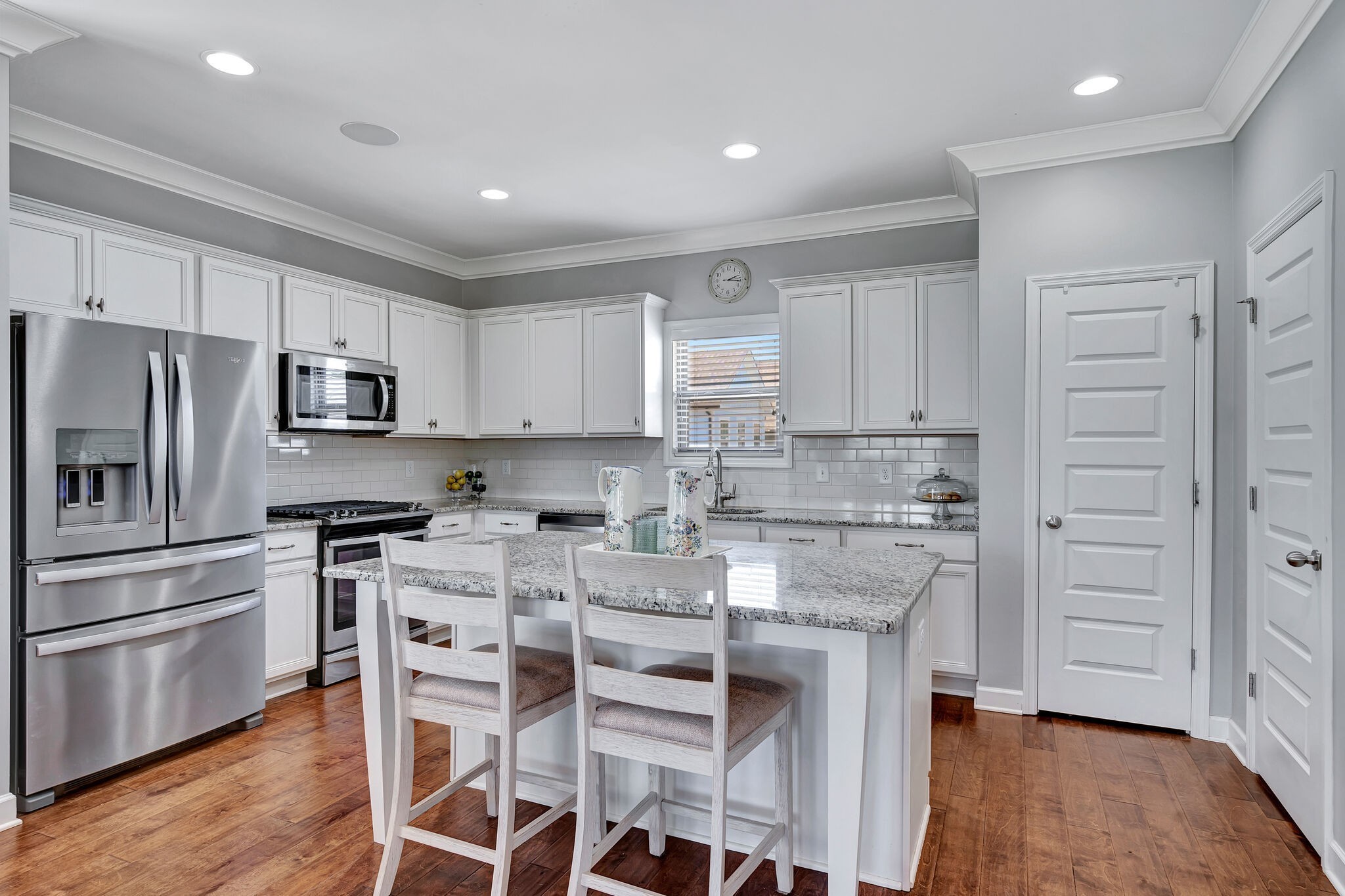 712 Bellevue Road Nashville, TN 37221 - Photo 7 of 31 a kitchen with granite countertop white cabinets and stainless steel appliances