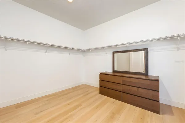 a room with a bed and mirror
