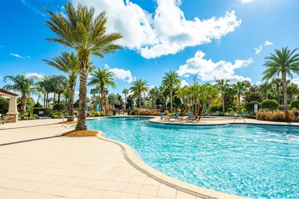 a view of swimming pool with a garden and trees