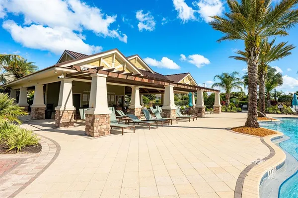a view of a house with sitting area and swimming pool