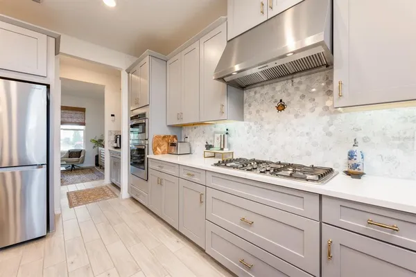 a kitchen with refrigerator and cabinets
