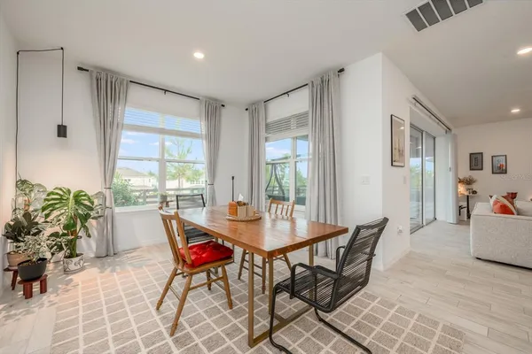 a dining room with furniture and wooden floor