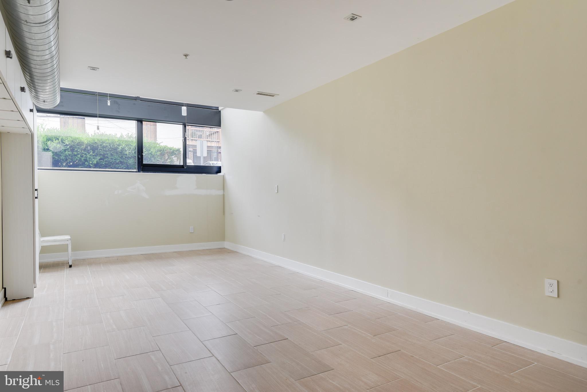 2250 11th Street Northwest, Unit 108 Washington, DC 20001 - Photo 8 of 26 a view of an empty room with window