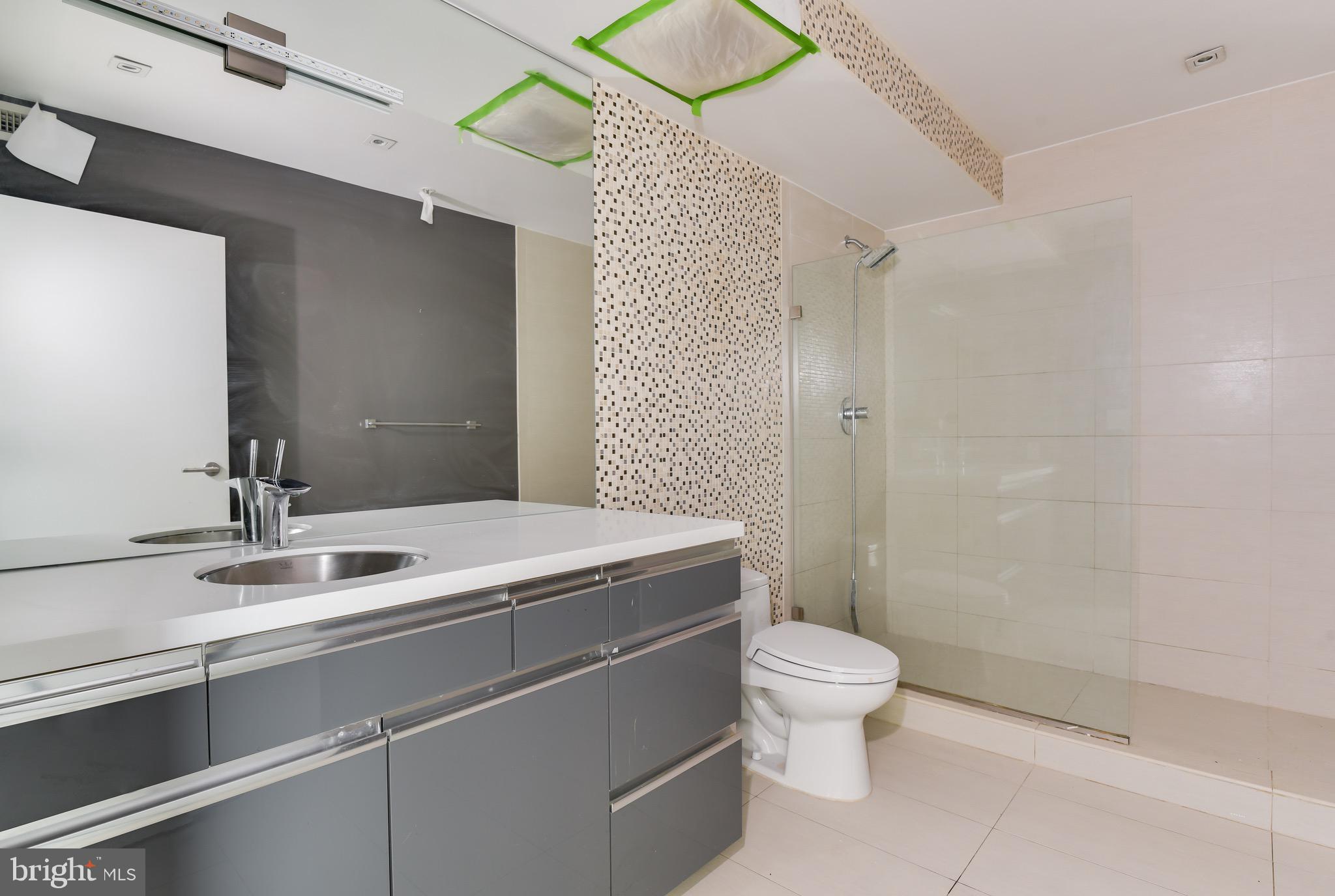 2250 11th Street Northwest, Unit 108 Washington, DC 20001 - Photo 10 of 26 a bathroom with a sink a toilet and shower