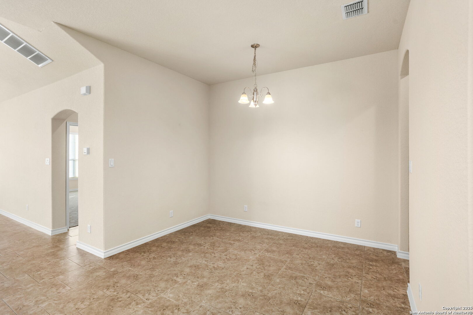 601 Saddle Villa Cibolo, TX 78108 - Photo 6 of 15 an empty room with a chandelier fan