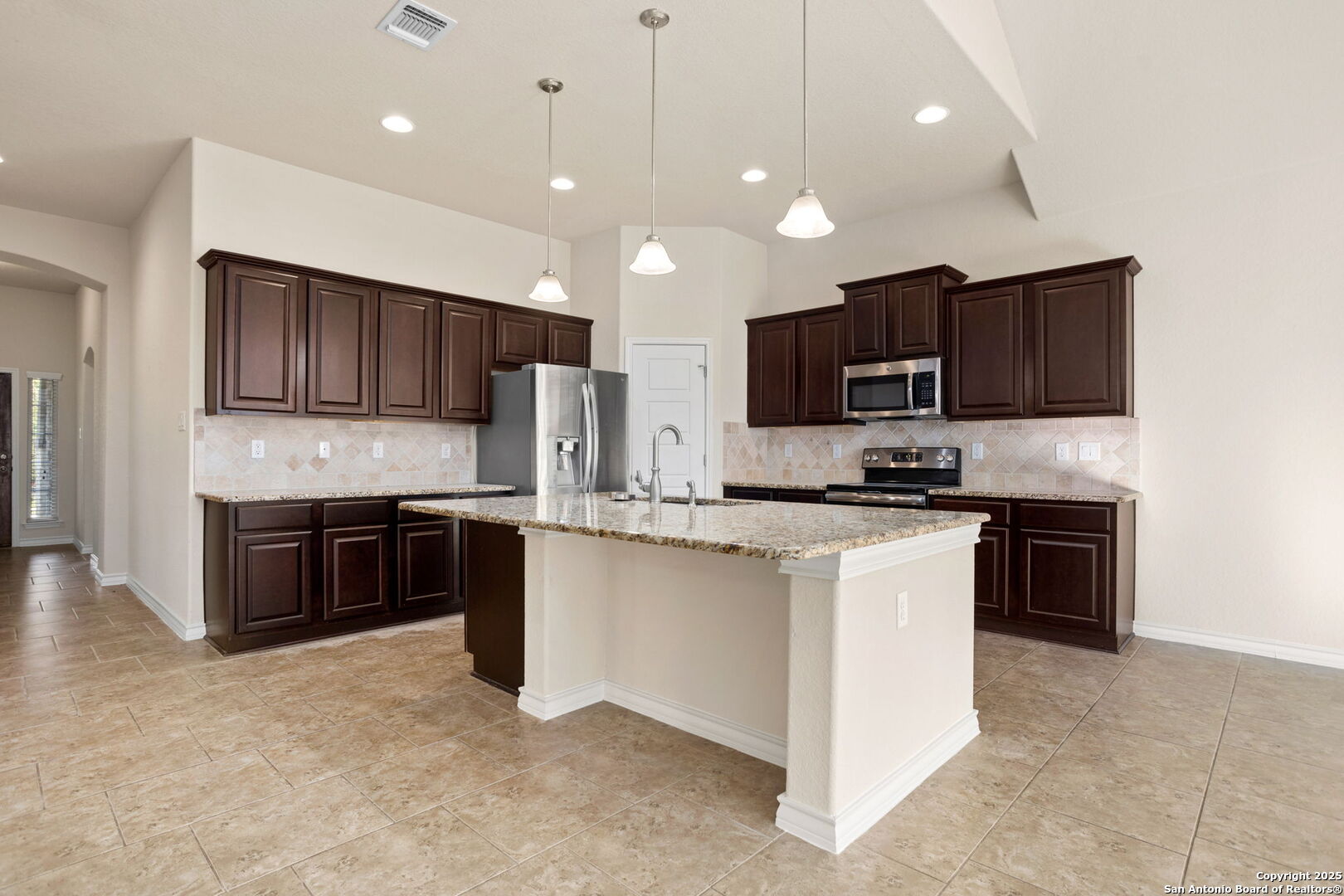 601 Saddle Villa Cibolo, TX 78108 - Photo 8 of 15 a large kitchen with a large counter top cabinets appliances and a sink