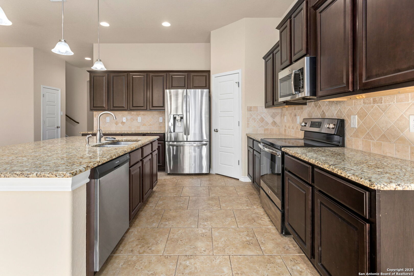 601 Saddle Villa Cibolo, TX 78108 - Photo 9 of 15 a kitchen with stainless steel appliances granite countertop a sink stove and refrigerator