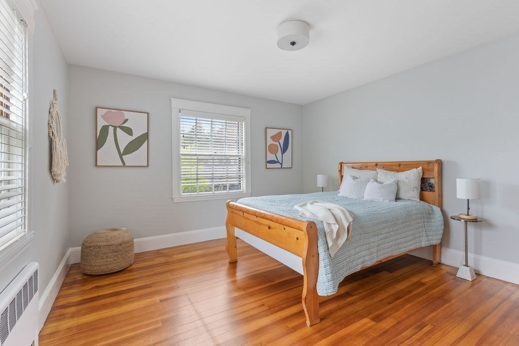 311 Clark Road Brookline, MA 02445 - Photo 12 of 26 a bedroom with a bed and wooden floor