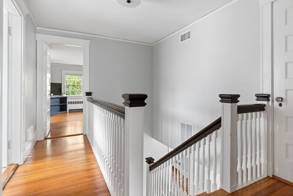 311 Clark Road Brookline, MA 02445 - Photo 15 of 26 a view of a hallway view with wooden floor and staircase
