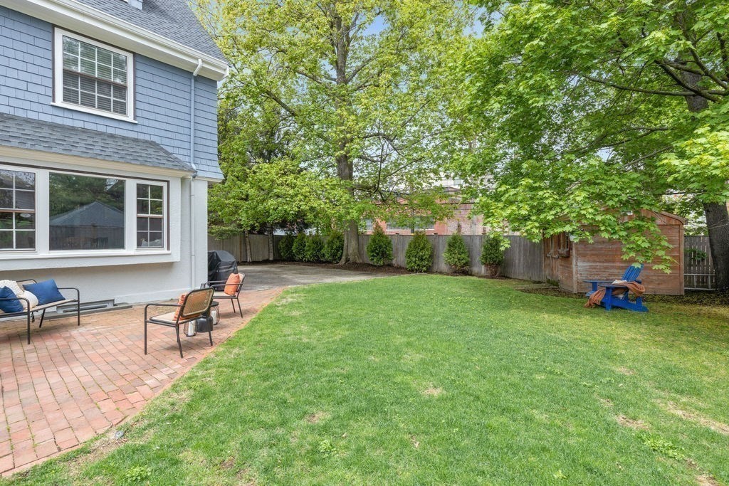 311 Clark Road Brookline, MA 02445 - Photo 24 of 26 a view of a house with backyard sitting area and garden