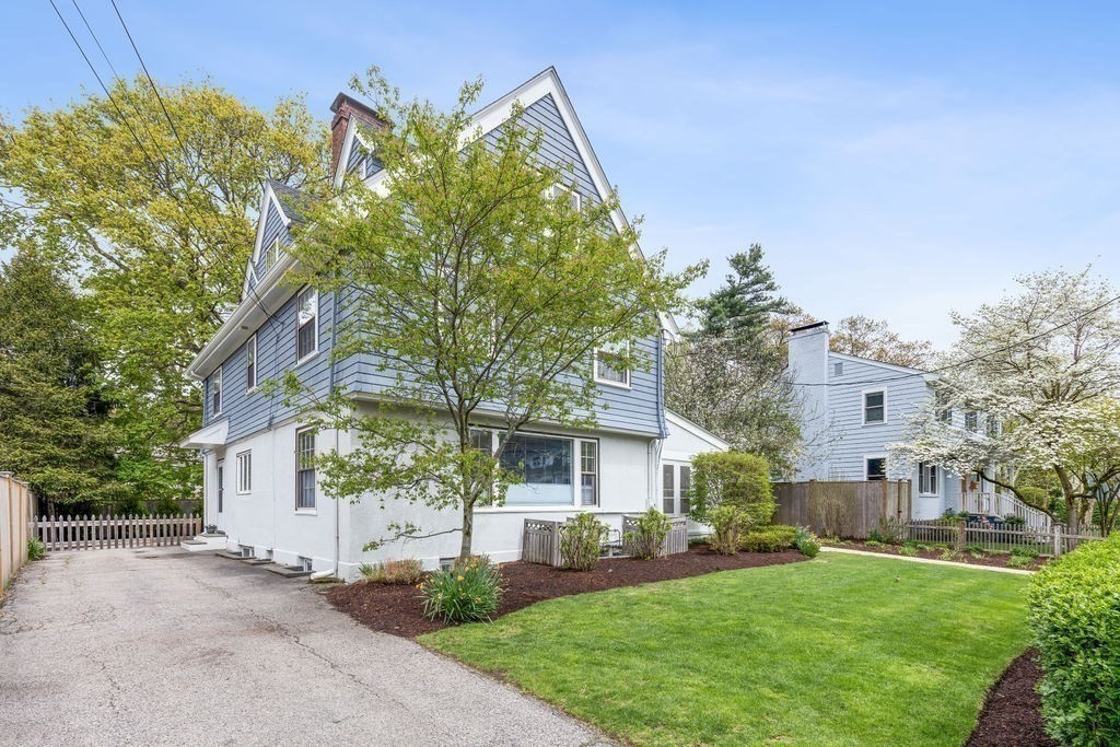 311 Clark Road Brookline, MA 02445 - Photo 25 of 26 a front view of a house with a garden and tree