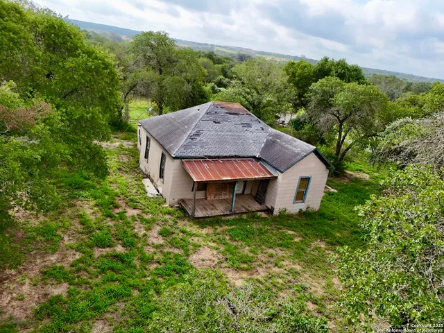 a view of a house with a yard and sitting area