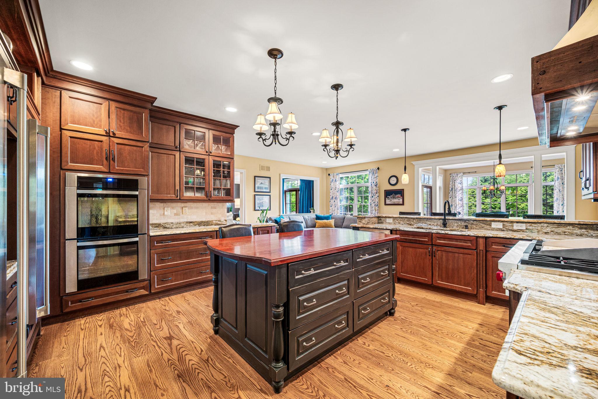 1548 Morstein Road Malvern, PA 19355 - Photo 27 of 80 a kitchen with stainless steel appliances granite countertop a stove and more cabinets