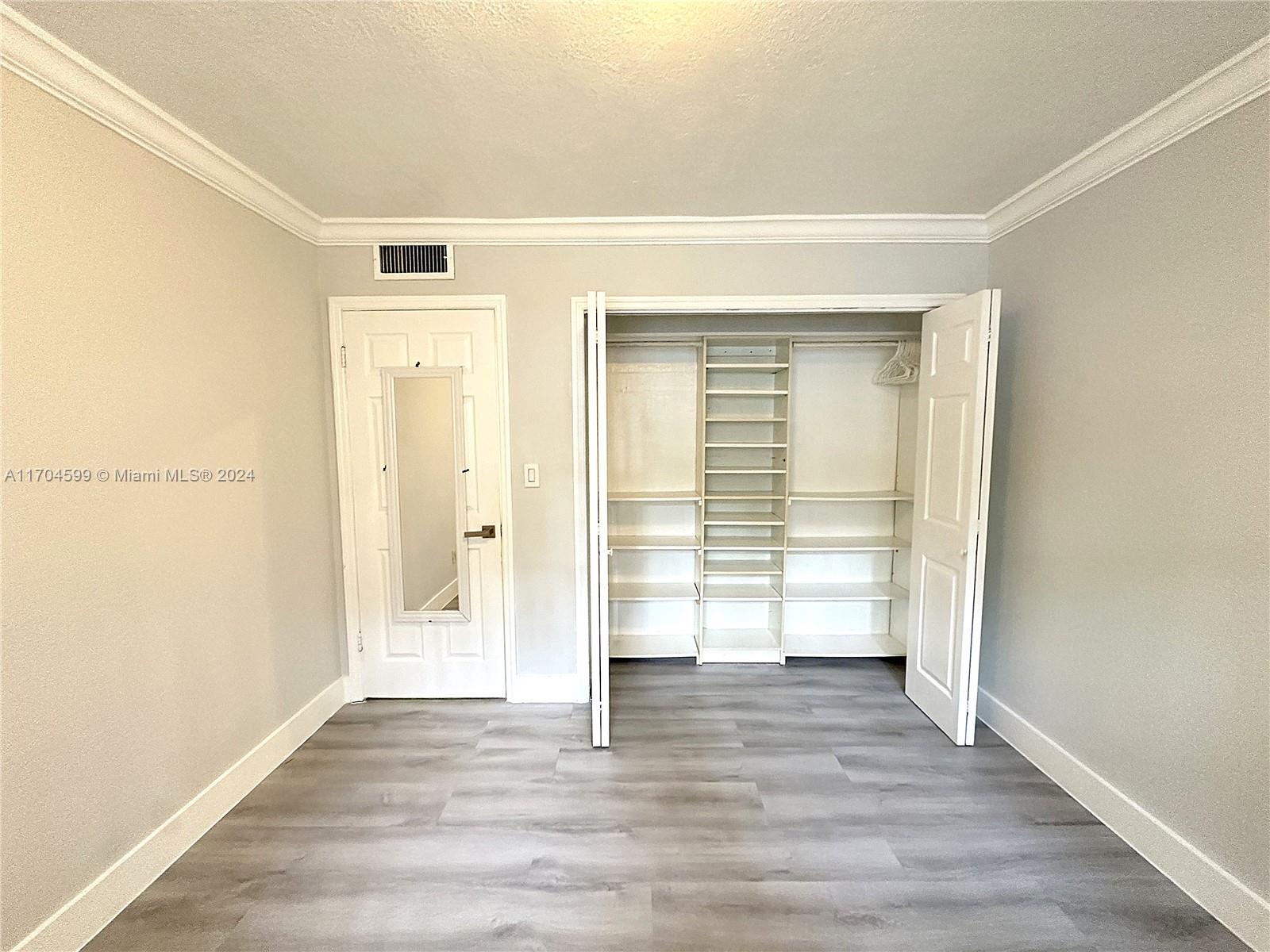 7101 Southwest 89th Court, Unit 110 Miami, FL 33173 - Photo 11 of 16 a view of empty room with wooden floor