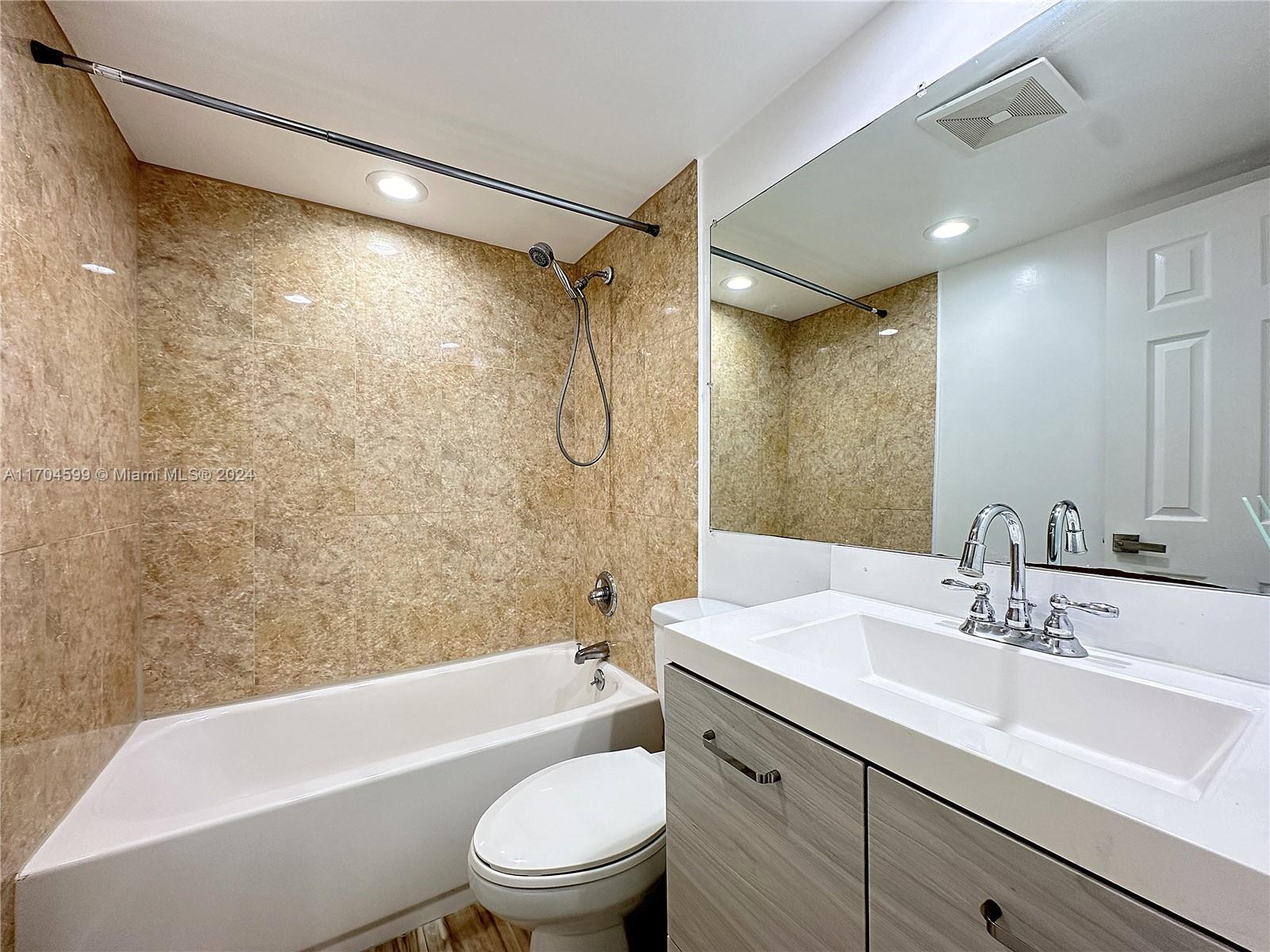 7101 Southwest 89th Court, Unit 110 Miami, FL 33173 - Photo 6 of 16 a bathroom with a sink mirror toilet and bathtub