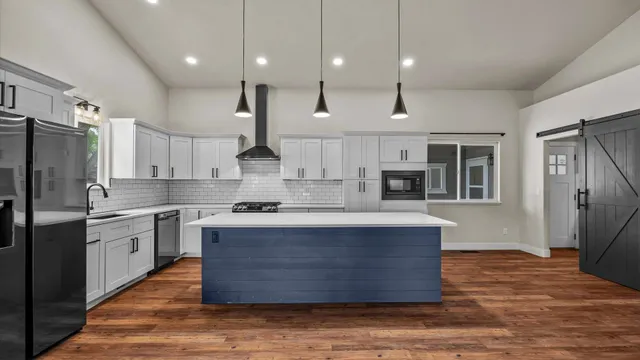 a kitchen with a sink a stove and cabinets