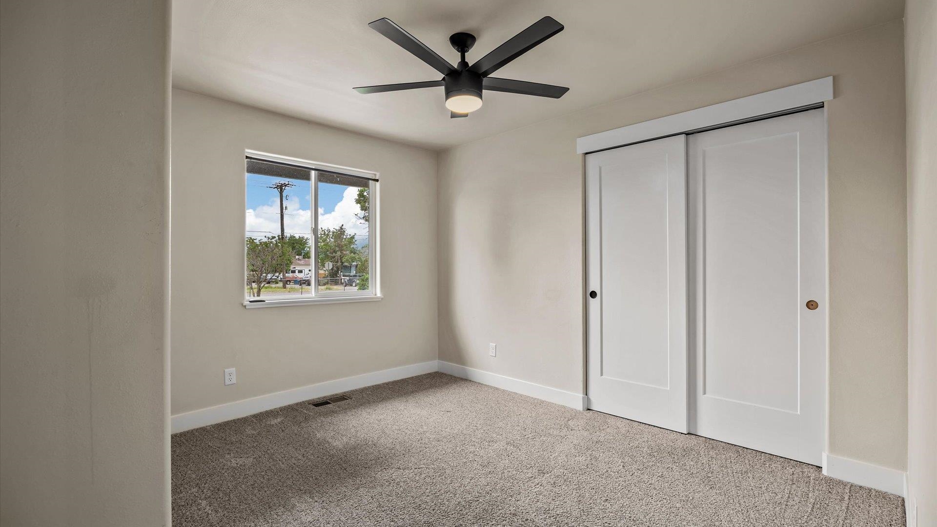3312 East 1/4 Road Clifton, CO 81520 - Photo 26 of 42 a view of a livingroom with a ceiling fan and window