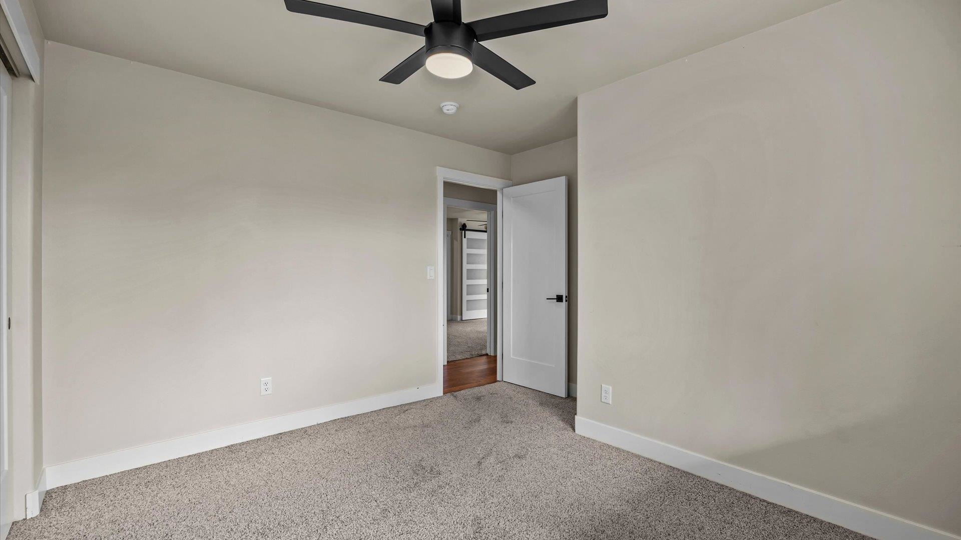 3312 East 1/4 Road Clifton, CO 81520 - Photo 27 of 42 an empty room with a empty space and a ceiling fan