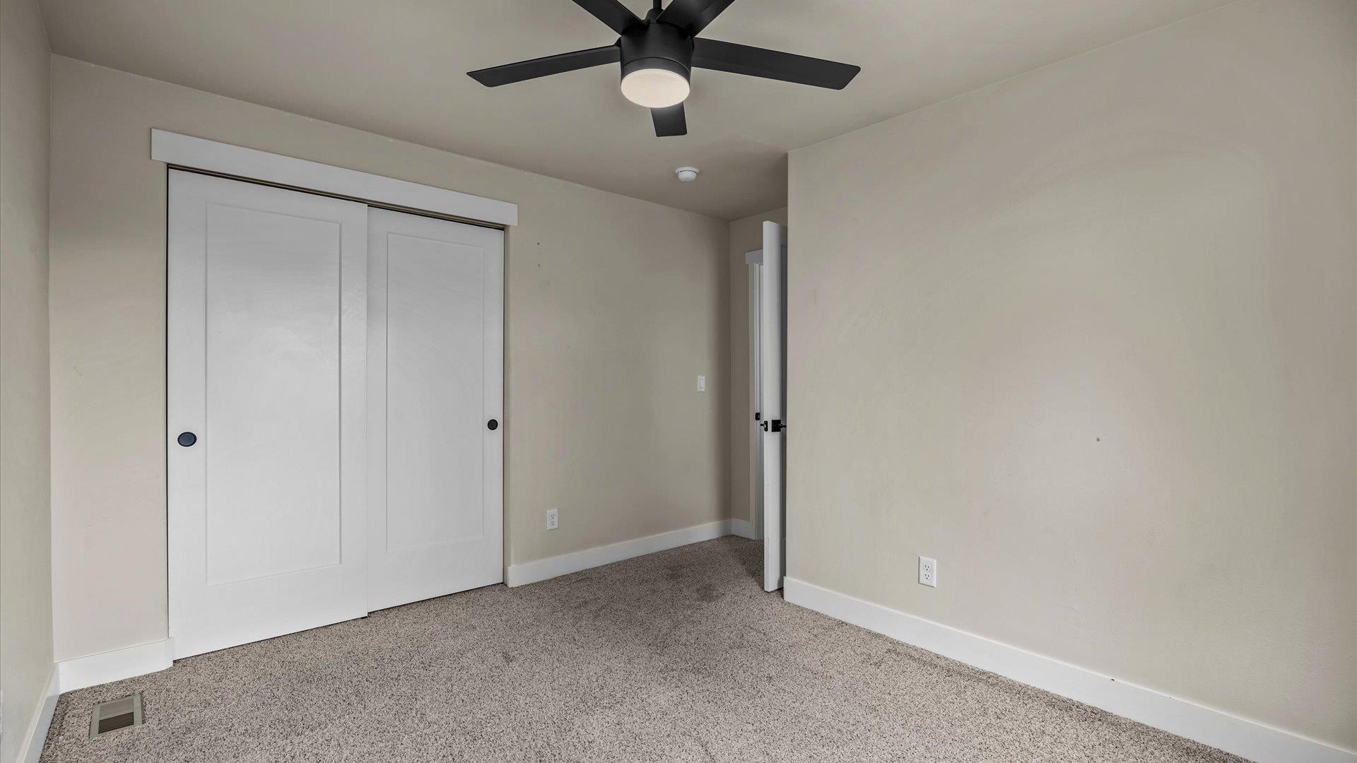 3312 East 1/4 Road Clifton, CO 81520 - Photo 29 of 42 a view of an empty room and a chandelier fan