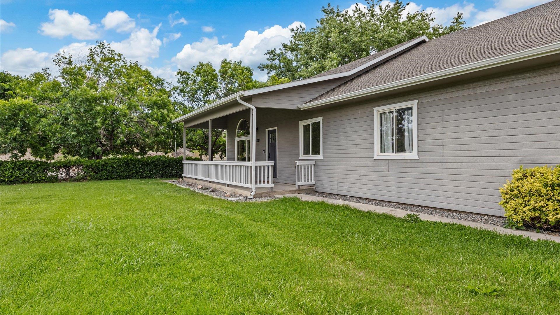 3312 East 1/4 Road Clifton, CO 81520 - Photo 6 of 42 a view of a house with a backyard and a garden