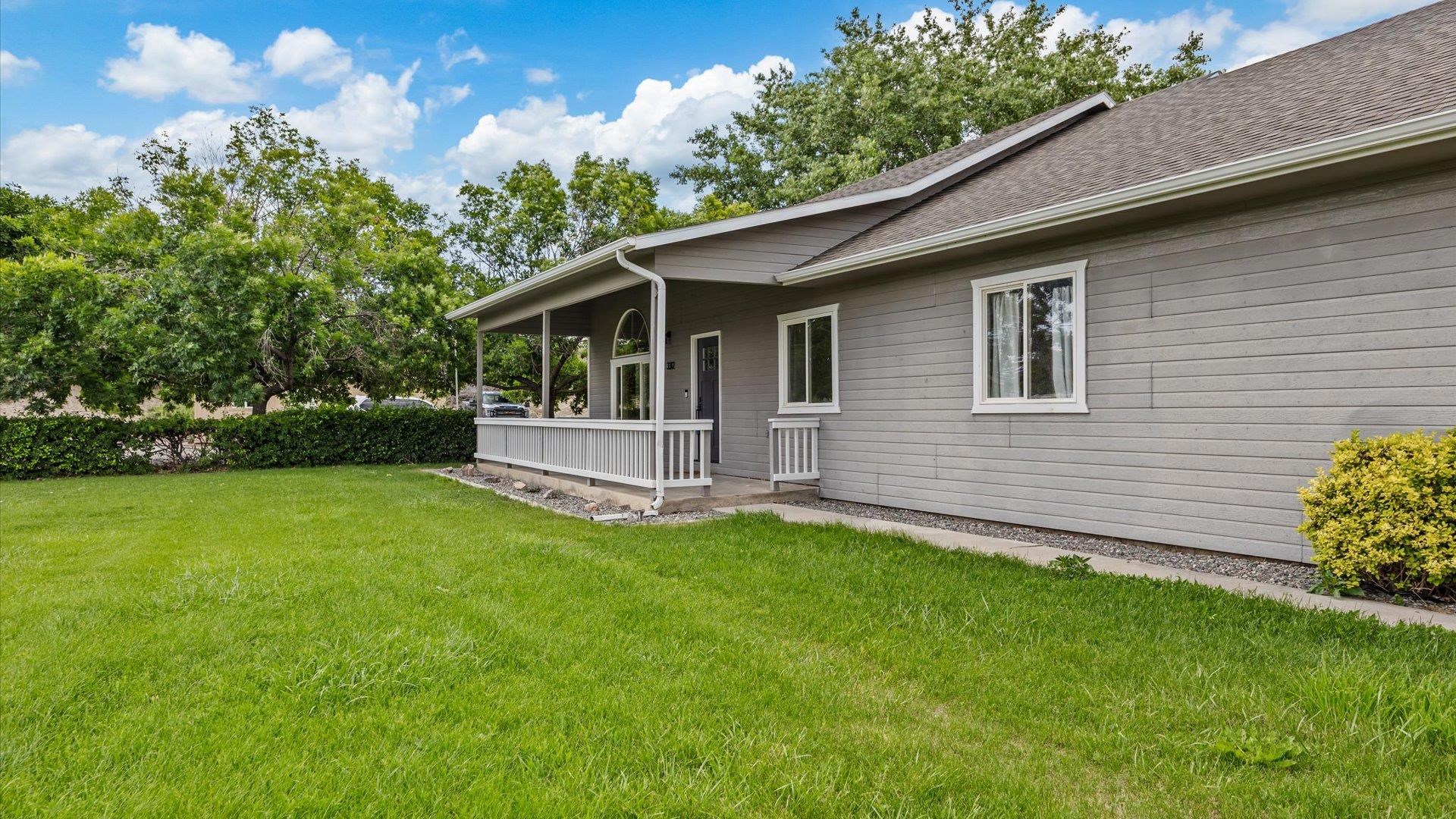 3312 East 1/4 Road Clifton, CO 81520 - Photo 10 of 42 a backyard of a house with table and chairs