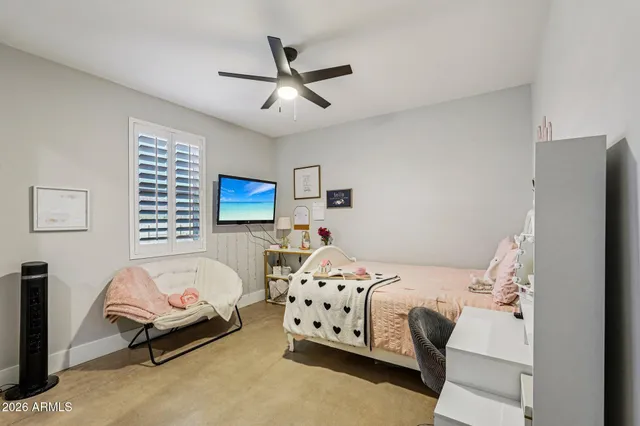 a bathroom with a granite countertop double vanity and a mirror
