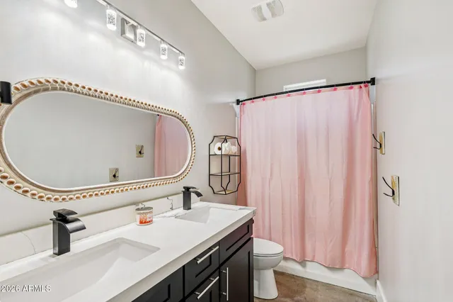 a bathroom with a sink and mirror with shower