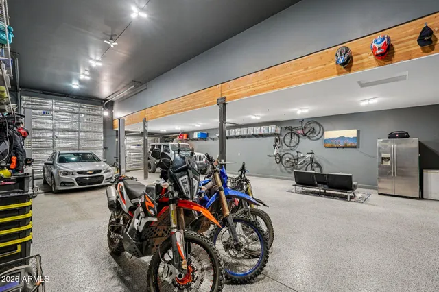 a bedroom with a large bed a chandelier and closet