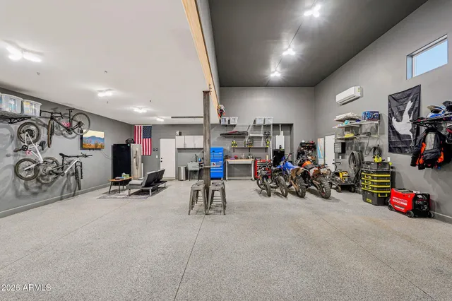 a view of a dining room with furniture a chandelier and a large window