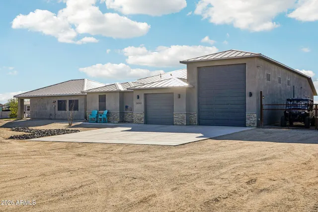 a dining room with stainless steel appliances kitchen island a table and chairs