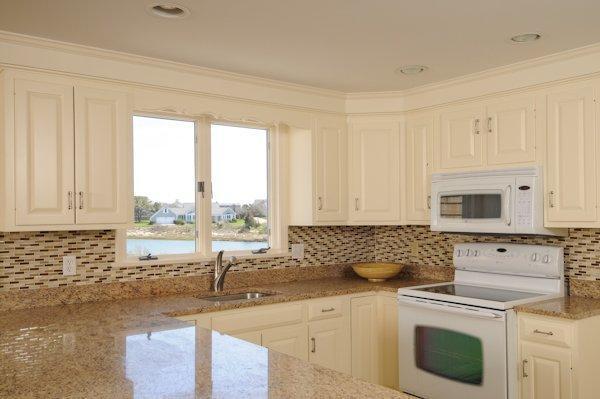 19 Nons Road Harwich Port, MA 02646 - Photo 6 of 12 a kitchen with granite countertop a sink stove top oven and cabinets